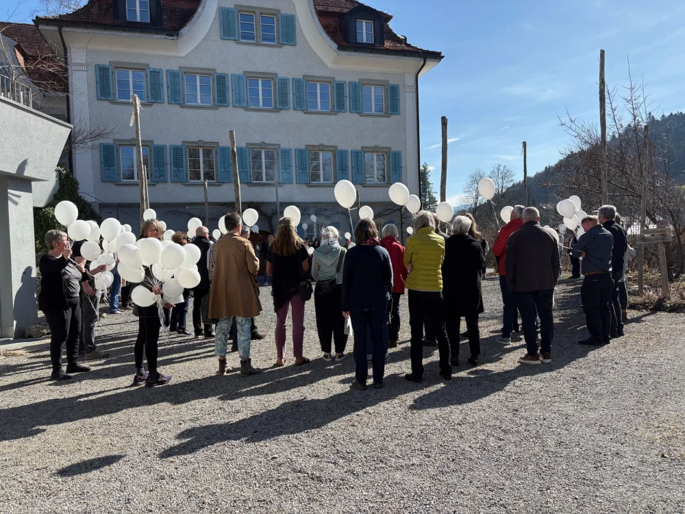 Hochzeitszeremonie im Freien mit der Hochzeitsgesellschaft und weissen Ballonen